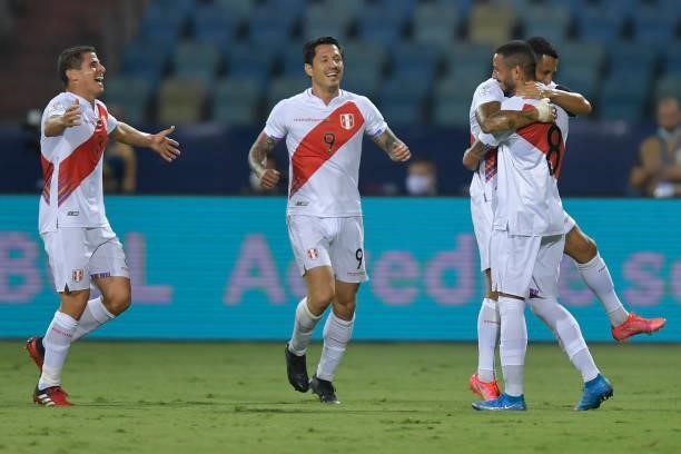 Sergio Peña of Peru celebrates with teammates after scoring the first goal of his team during a group b match between Colombia and Peru as part of...