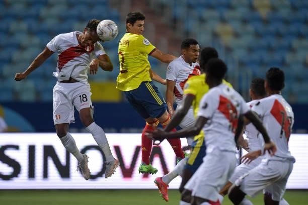 André Carrillo of Peru heads the ball against Stefan Medina of Colombia during a group b match between Colombia and Peru as part of Copa America...