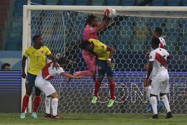 Pedro Gallese goalkeeper of Peru jumps for the ball against Miguel Borja of Colombia during a group b match between Colombia and Peru as part of Copa...