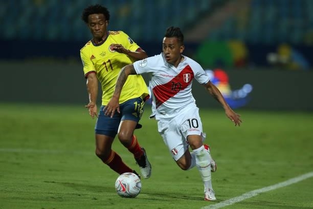 Juan Cuadrado of Colombia competes for the ball with Christian Cueva of Peru during a group b match between Colombia and Peru as part of Copa America...