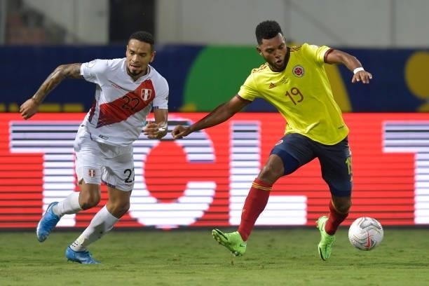 Alexander Callens of Peru competes for the ball with Miguel Borja of Colombia during a group b match between Colombia and Peru as part of Copa...