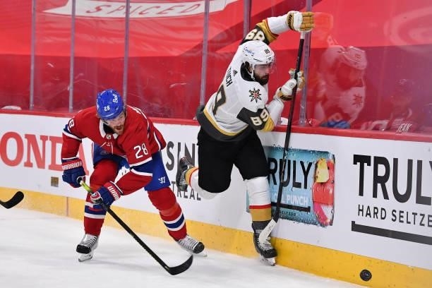 Alex Tuch of the Vegas Golden Knights and Jon Merrill of the Montreal Canadiens battle for the puck during the first period in Game Four of the...