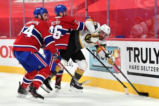 William Carrier of the Vegas Golden Knights is checked by Jeff Petry of the Montreal Canadiens during the first period in Game Four of the Stanley...