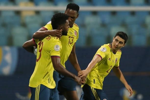 Miguel Borja of Colombia celebrates with teammates Yerry Mina and Stefan Medina after scoring the first goal of his team during a group B match...