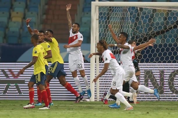 Alexander Callens and Aldo Corzo of Peru celebrate with teammates after their second goal scored by an own goal of Yerry Mina of Colombia during a...