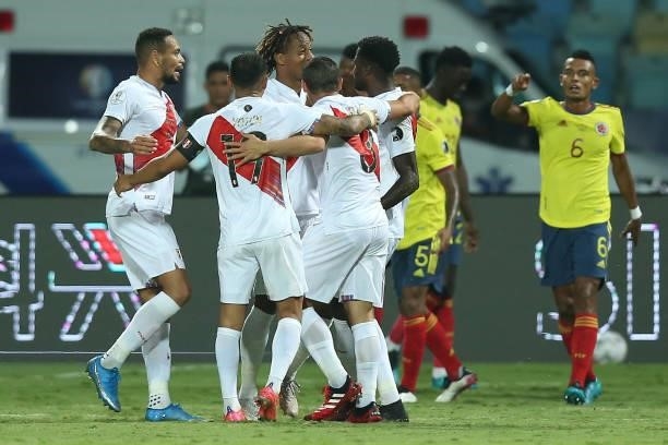 Alexander Callens, Yoshimar Yotún and Sergio Peña of Peru celebrate with teammates after their second goal scored by an own goal of Yerry Mina of...