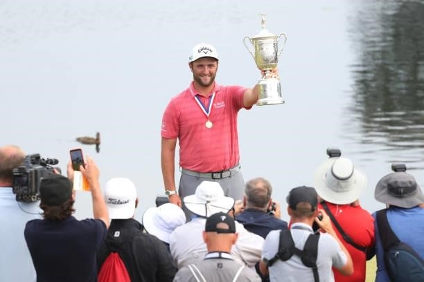 Jon Rahm of Spain celebrates with the trophy after winning as the media takes photographs during the trophy presentation ceremony after the final...