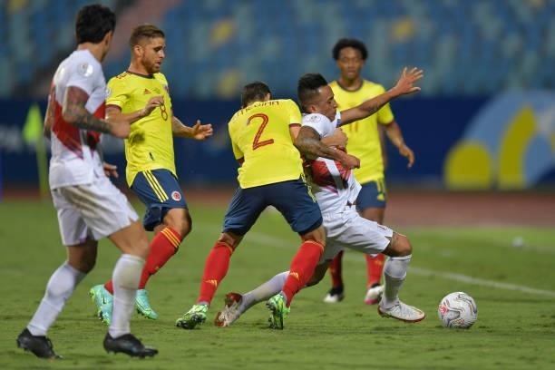 Stefan Medina of Colombia competes for the ball with Christian Cueva of Peru during a group B match between Colombia and Peru as part of Copa America...