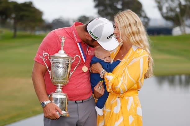 Jon Rahm of Spain celebrates with the trophy alongside his wife, Kelley, and son, Kepa, after winning during the final round of the 2021 U.S. Open at...