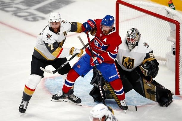 Robin Lehner of the Vegas Golden Knights tends net as Alex Pietrangelo and Paul Byron of the Montreal Canadiens battle in front during the second...