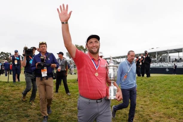 Jon Rahm of Spain celebrates with the trophy as he leaves the trophy ceremony after winning during the final round of the 2021 U.S. Open at Torrey...