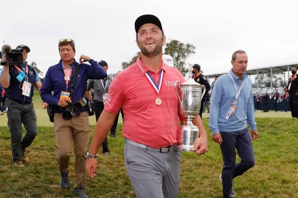 Jon Rahm of Spain celebrates with the trophy as he leaves the trophy ceremony after winning during the final round of the 2021 U.S. Open at Torrey...