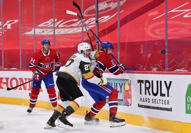Shea Theodore of the Vegas Golden Knights and Eric Staal of the Montreal Canadiens eye the loose puck during the second period in Game Four of the...