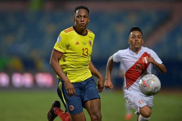 Yerry Mina of Colombia competes for the ball with Christian Cueva of Peru during a group B match between Colombia and Peru as part of Copa America...