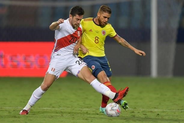 Santiago Ormeño of Peru competes for the ball with Gustavo Cuellar of Colombia during a group B match between Colombia and Peru as part of Copa...