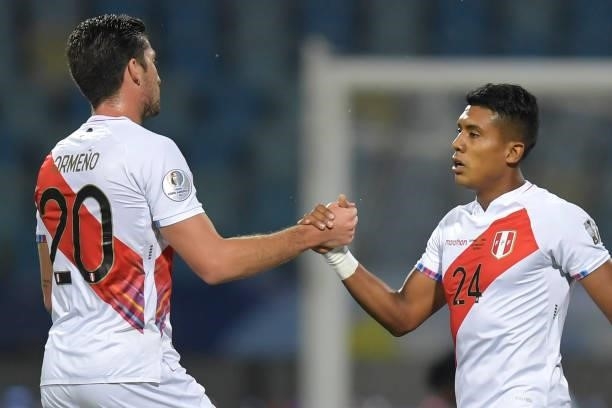 Santiago Ormeño of Peru celebrates with teammate Raziel García after winning a group B match between Colombia and Peru as part of Copa America Brazil...