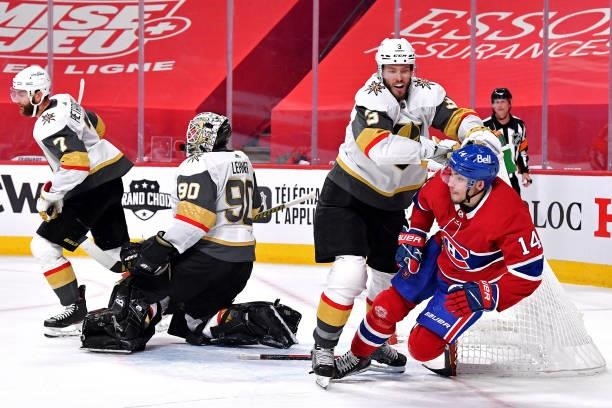 Nick Suzuki of the Montreal Canadiens is checked by Brayden McNabb of the Vegas Golden Knights during the second period in Game Four of the Stanley...