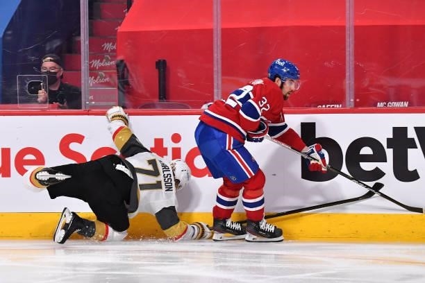 William Karlsson of the Vegas Golden Knights gets tripped up against Erik Gustafsson of the Montreal Canadiens during the third period in Game Four...