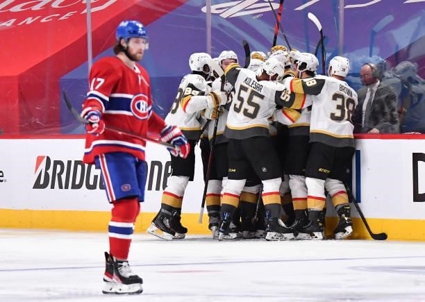 Nicolas Roy of the Vegas Golden Knights is congratulated by his teammates after scoring the game-winning goal in overtime as Josh Anderson of the...