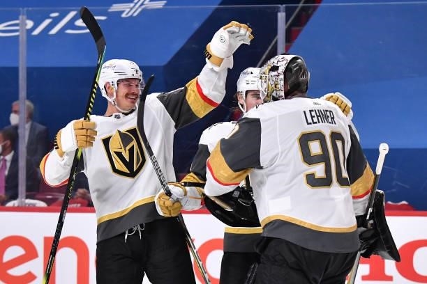 Nick Holden, Zach Whitecloud and Robin Lehner of the Vegas Golden Knights celebrate their team's 2-1 overtime victory against the Montreal Canadiens...