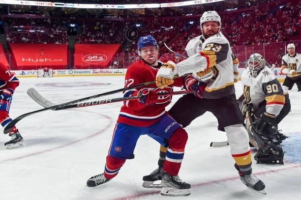 Cole Caufield of the Montreal Canadiens and Alec Martinez of the Vegas Golden Knights battle for the puck during the third period in Game Four of the...