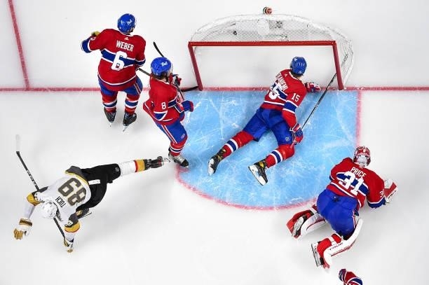 Carey Price and Jesperi Kotkaniemi of the Montreal Canadiens react after their 2-1 overtime loss to the Vegas Golden Knights in Game Four of the...