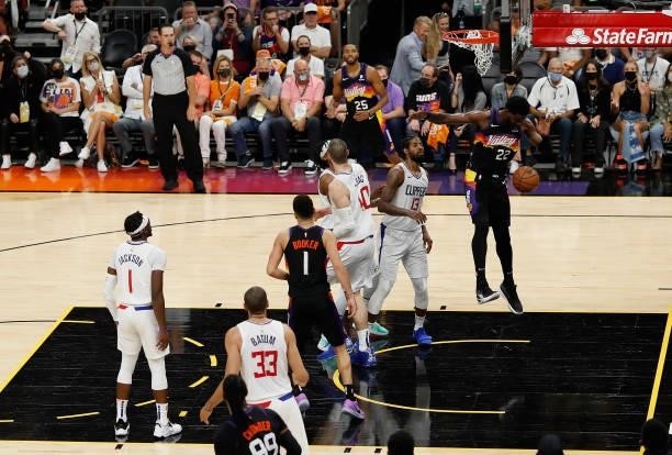 Deandre Ayton of the Phoenix Suns slam dunks the ball past Paul George of the LA Clippers during the second half of game one of the Western...