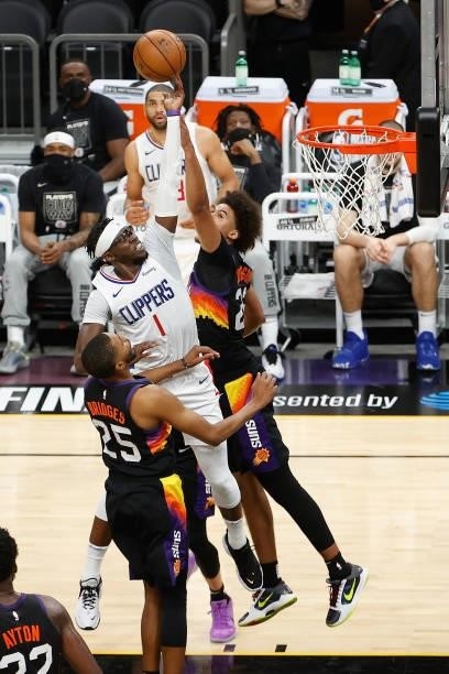 Reggie Jackson of the LA Clippers attempts a shot over Mikal Bridges of the Phoenix Suns during the second half of game one of the Western Conference...