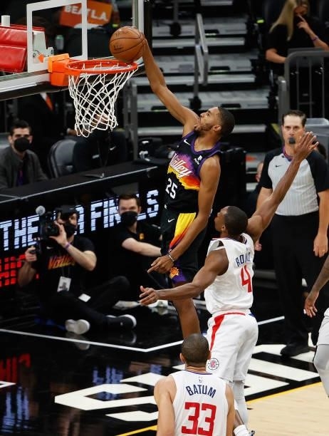Mikal Bridges of the Phoenix Suns slam dunks the ball ahead of Rajon Rondo of the LA Clippers during the second half of game one of the Western...