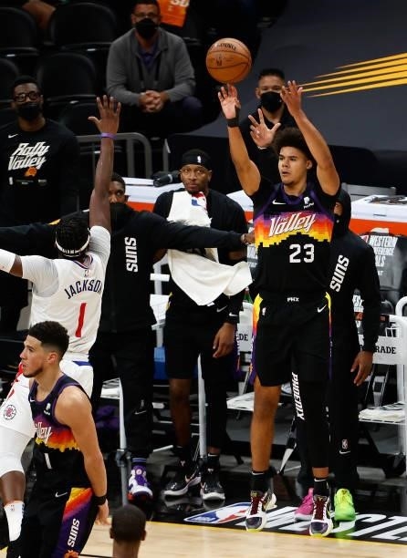 Cameron Johnson of the Phoenix Suns attempts a three-point shot over Reggie Jackson of the LA Clippers during the second half of game one of the...