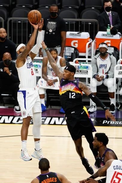 Marcus Morris Sr. #8 of the LA Clippers attempts a shot over Torrey Craig of the Phoenix Suns during the second half of game one of the Western...