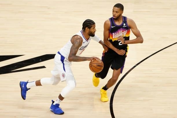 Paul George of the LA Clippers controls the ball against Cameron Johnson of the Phoenix Suns during the second half of game one of the Western...