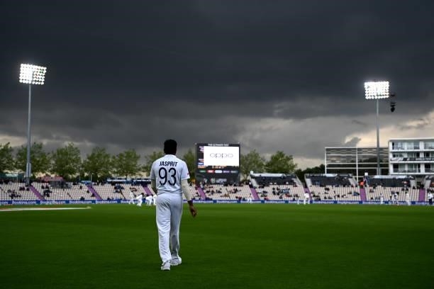 Jasprit Bumrah of India fields on the boundary as dark clouds gather during Day 3 of the ICC World Test Championship Final between India and New...