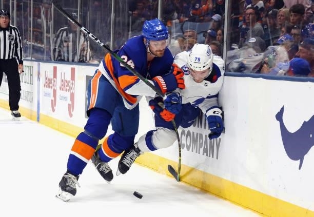 Scott Mayfield of the New York Islanders checks Ross Colton of the Tampa Bay Lightning in Game Four of the Stanley Cup Semifinals during the 2021...