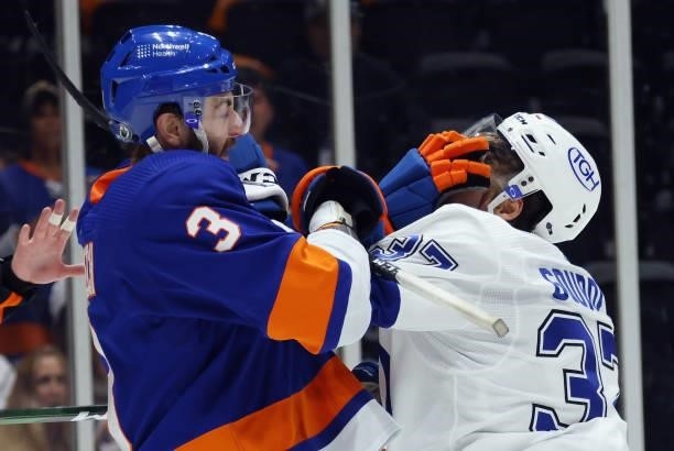 Adam Pelech of the New York Islanders battles with Yanni Gourde of the Tampa Bay Lightning in Game Four of the Stanley Cup Semifinals during the 2021...