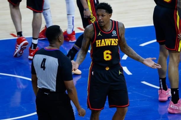 Lou Williams of the Atlanta Hawks speaks with referee Sean Wright during the first quarter during Game Seven of the Eastern Conference Semifinals...
