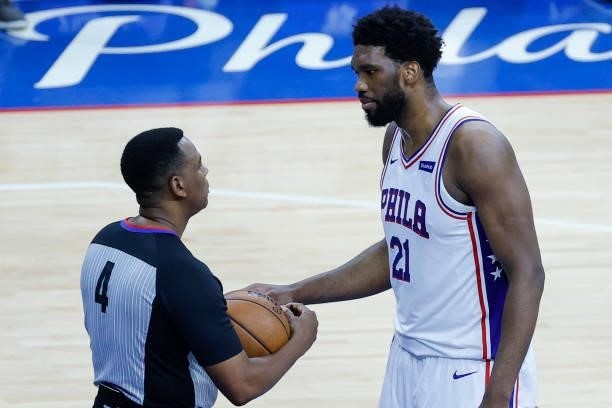 Joel Embiid of the Philadelphia 76ers speaks with referee Sean Wright during the second quarter during Game Seven of the Eastern Conference...