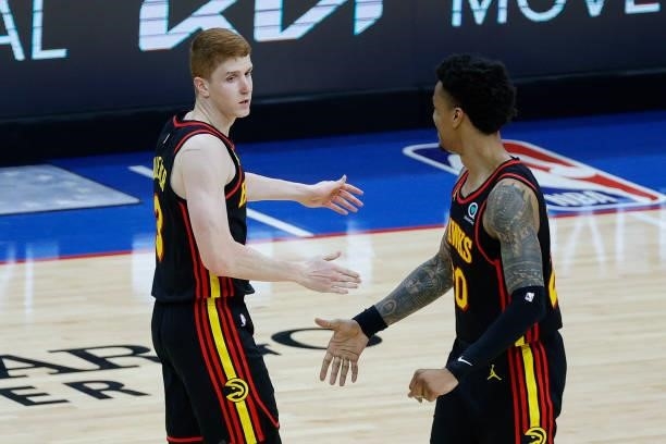 Kevin Huerter and John Collins of the Atlanta Hawks celebrate during the third quarter against the Philadelphia 76ers during Game Seven of the...