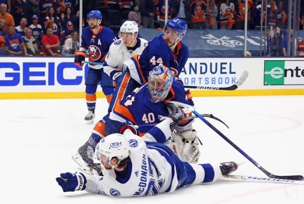 The New York Islanders and the Tampa Bay Lightning look back to watch Ryan Pulock block a last second shot by Ryan McDonagh in Game Four of the...