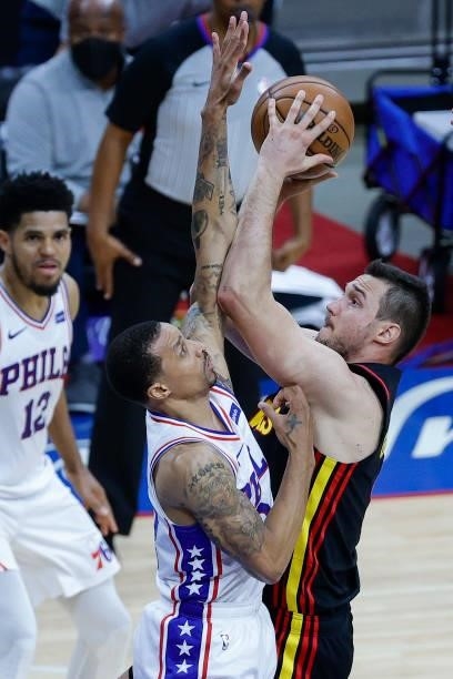 Danilo Gallinari of the Atlanta Hawks shoots over George Hill of the Philadelphia 76ers during the third quarter during Game Seven of the Eastern...