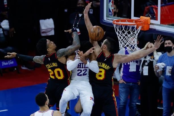 Matisse Thybulle of the Philadelphia 76ers drives between John Collins and Danilo Gallinari of the Atlanta Hawks during the fourth quarter during...