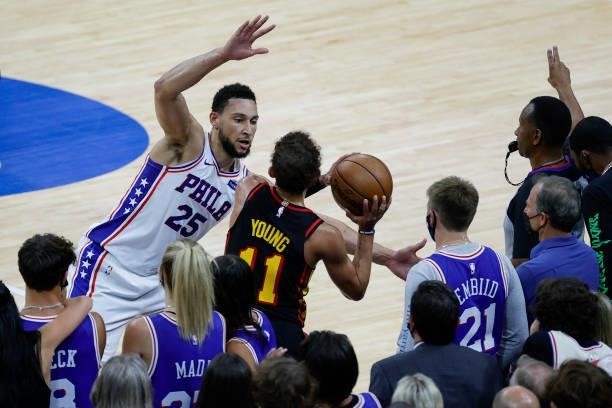 Ben Simmons of the Philadelphia 76ers guards Trae Young of the Atlanta Hawks during the fourth quarter during Game Seven of the Eastern Conference...