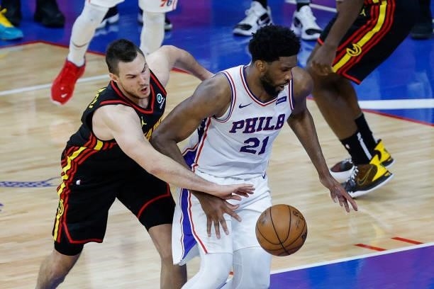 Danilo Gallinari of the Atlanta Hawks guards Joel Embiid of the Philadelphia 76ers during the fourth quarter during Game Seven of the Eastern...