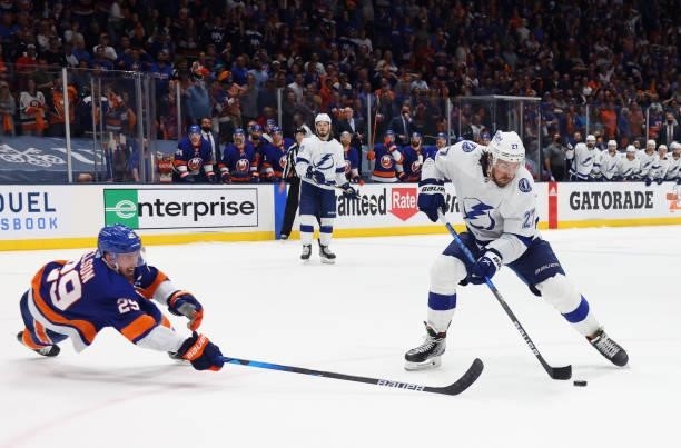 Ryan McDonagh of the Tampa Bay Lightning starts the spinarama move in the closing seconds of his game against Brock Nelson and the New York Islanders...