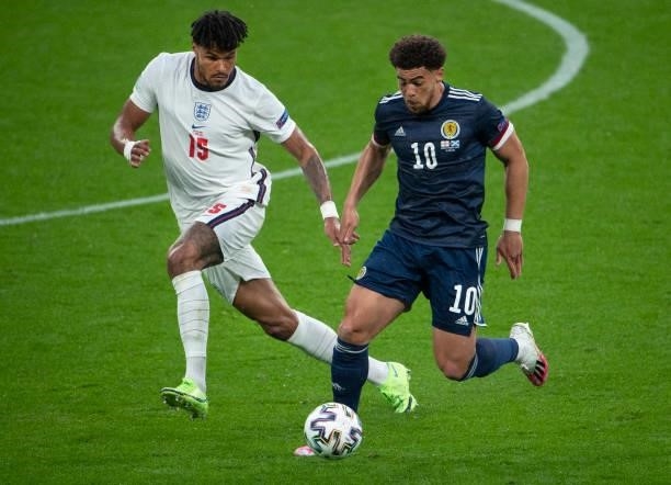 Ché Adams of Scotland and Tyrone Mings of England in action during the UEFA Euro 2020 Championship Group D match between England and Scotland at...