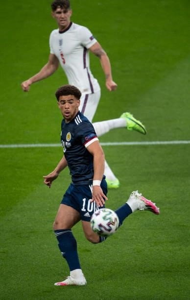 Ché Adams of Scotland and John Stones of England in action during the UEFA Euro 2020 Championship Group D match between England and Scotland at...
