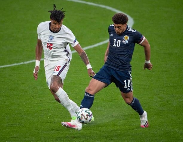 Ché Adams of Scotland and Tyrone Mings of England in action during the UEFA Euro 2020 Championship Group D match between England and Scotland at...
