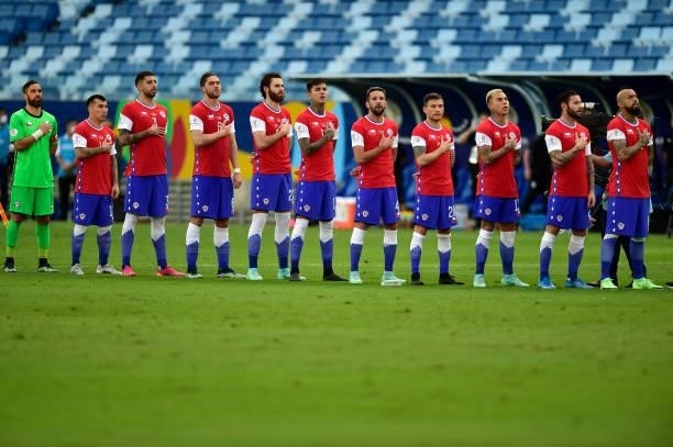 Players of Chile sing their national anthem before a group A match between Uruguay and Chile as part of Conmebol Copa America Brazil 2021 at Arena...