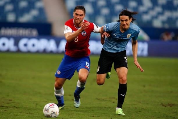 Francisco Sierralta of Chile competes for the ball with Edinson Cavani of Uruguay during a group A match between Uruguay and Chile as part of...
