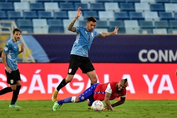 Matias Vecino of Uruguay competes for the ball with Arturo Vidal of Chile during a group A match between Uruguay and Chile as part of Conmebol Copa...